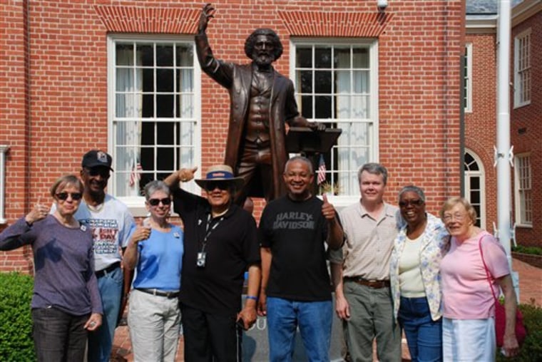 Members of the Frederick Douglass Honor Society pose next to a statue of the famed abolitionist in Easton, Md. 